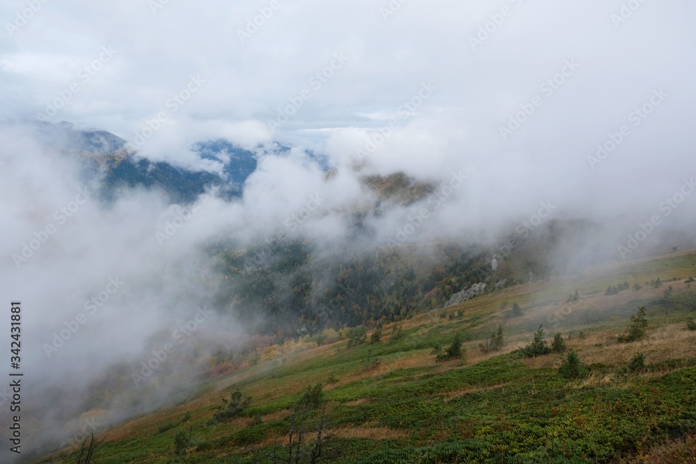 Beautiful mountain autumn view with low clouds on the route from the Mt. Megruki peak to Atskuri. Borjomi-Kharagauli National Park, Georgia. 