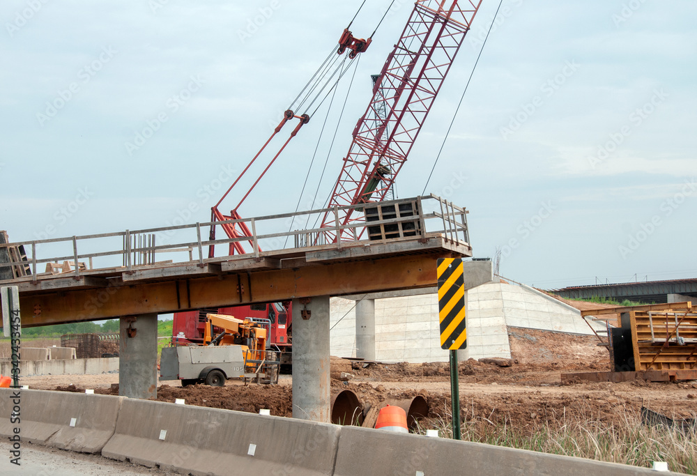 Highway construction with crane closeup