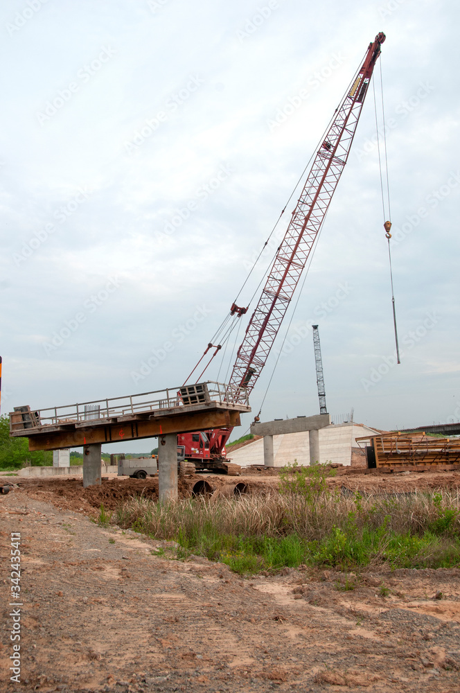 Highway overpass construction with tall crane