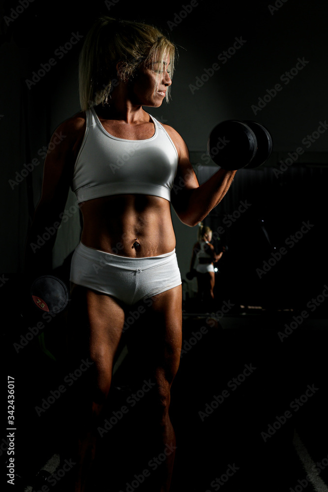 Female athlete practicing weight training exercises in postpartum during the covid-19 quarantine Female athlete practicing weight training exercises in postpartum during the covid-19 quarantine