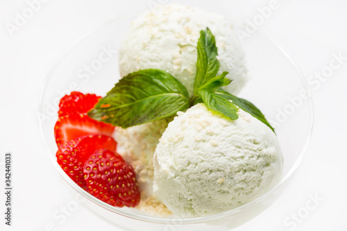 Ice cream balls decorate with mint on a white background in a restaurant. 