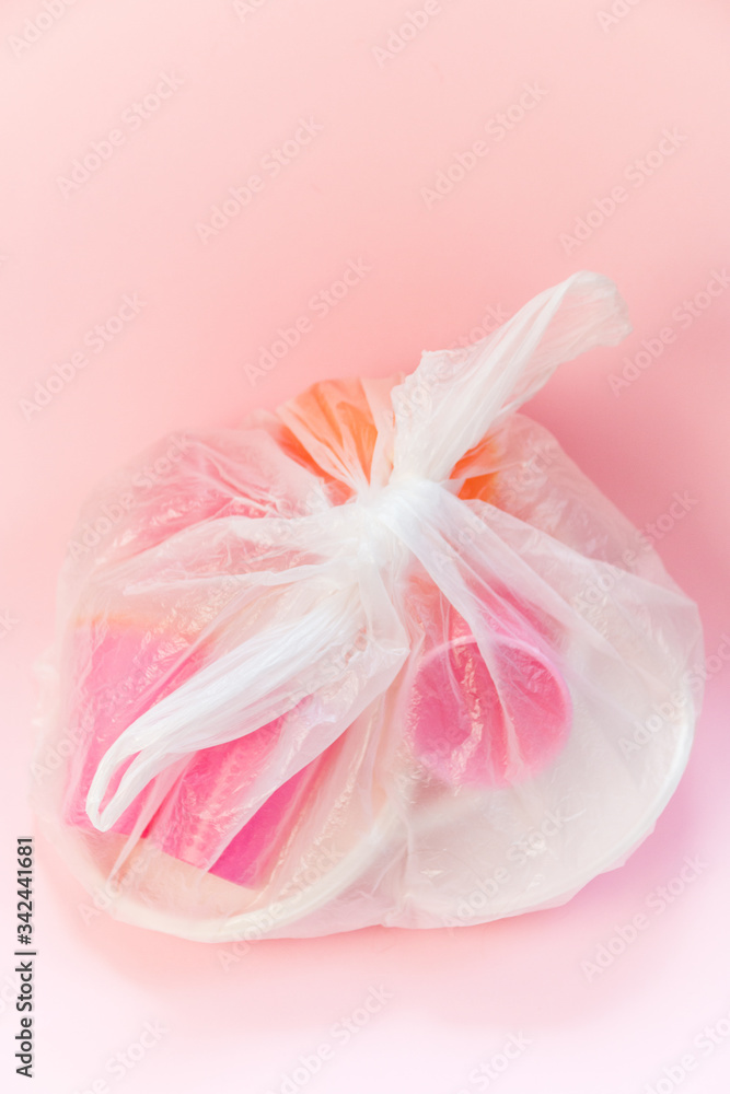 Plastic waste in a bag on a pink background. Concept of plastic recycling and the environment. Flatlay top view, Selective focus Plastic waste in a bag on a pink background. Concept of plastic recycling and the environment. Flatlay top view, Selective focus
