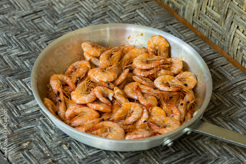 Cooking tiger prawns in a pan shot close-up. 