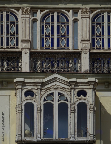 Revival building with beautiful enclosed glazed balconies in the old city center of Malaga. Spain.