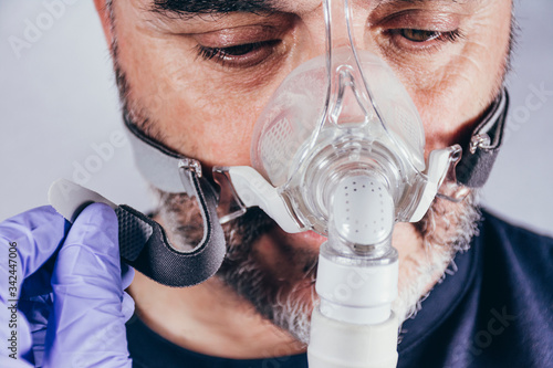 Man with respiratory mask for assisted breathing photo