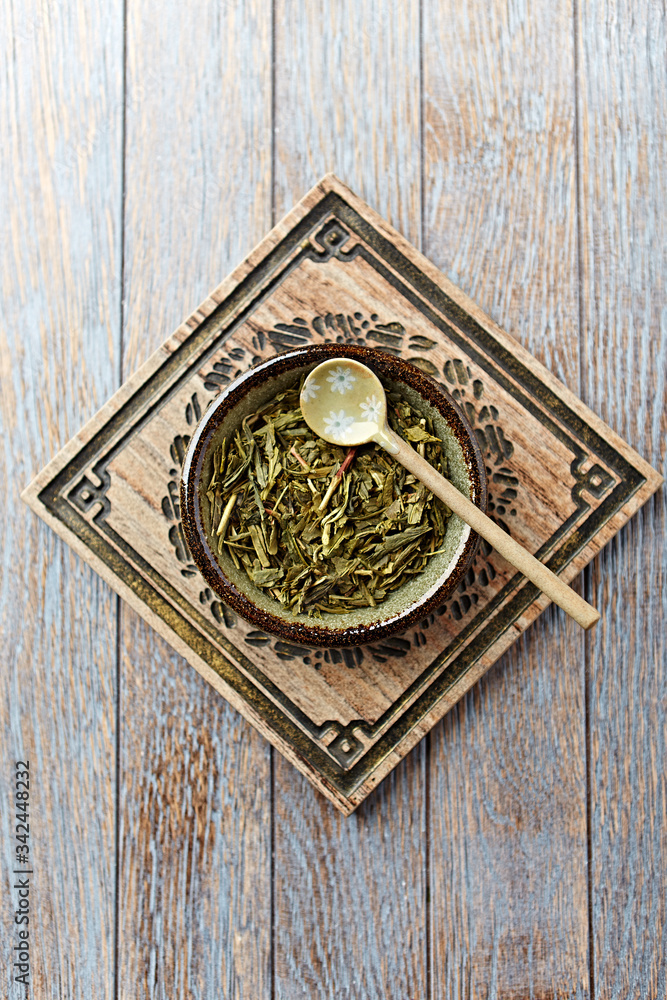 Dried Green Tea Leaves on Bright Background. Top view. 	