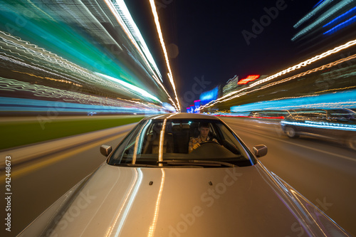 View from Front of Car moving in a night city, Blured road with lights with car on high speed.