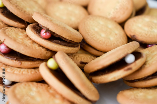 Close up of round biscuits filled with hazelnut spread and candy, South Africa photo