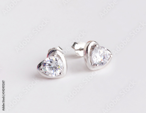 A pair of beautiful 925 sterling silver earrings in heart shape isolated