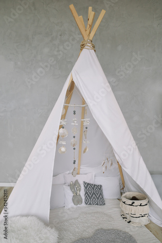 Nursery in Scandinavian style. Scandi child room interior in real photo. Decorative boho styled hut, tipi, wigwam © paralisart
