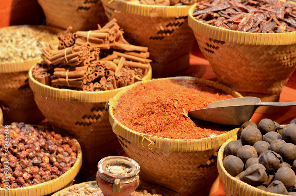 Fototapeta premium Rows & heaps of aromatic spices & herbs on display at the famous Spice Souk market in Baniyas Street, in locality of Al Ras, Deira, Dubai adjacent to the Gold Souk. It's a famous tourist destination