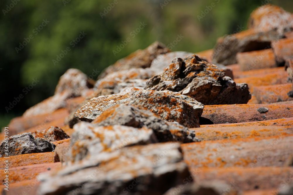 Stones on a roof and out of focus in the foreground Stones on a roof and out of focus in the foreground