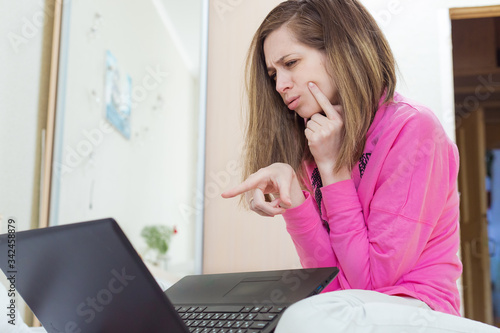 Girl communicates via laptop remotely. Face emotion surprise
