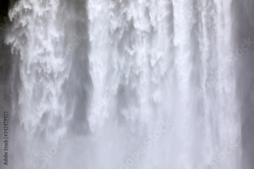 Skogafoss / Iceland - August 15, 2017: Beautiful and famous Skogafoss waterfall in South of Iceland, Iceland, Europe