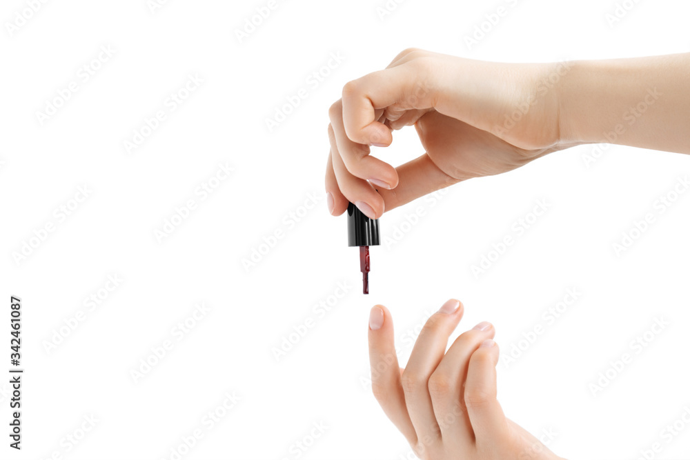 Woman covers her nails with red nail polish. Isolated on white background. Woman covers her nails with red nail polish. Isolated on white background.