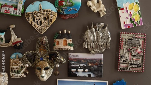 Putting travel magnets from vacations Florence Italy (Italiano Firenze) on a fridge, travel concept