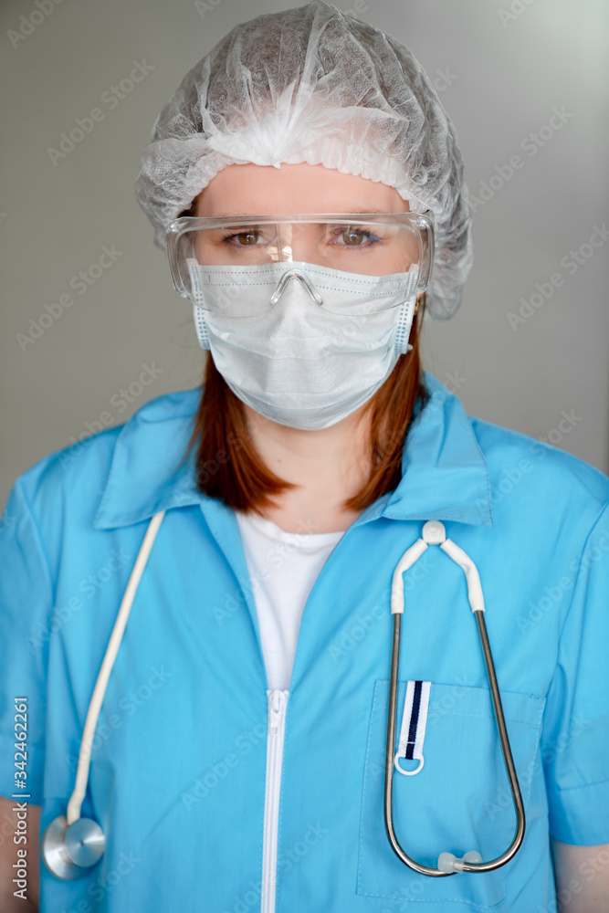 Doctor in protective medical mask, blue uniform. Doctor in protective medical mask, blue uniform.