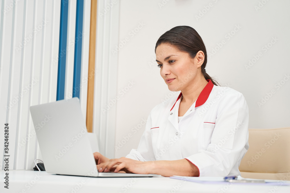 Concentrated brunette female person working at computer Concentrated brunette female person working at computer