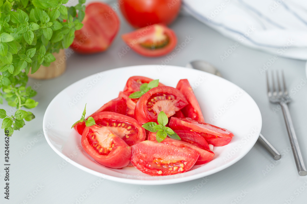 Tomato salad with basil and olive oil in bowl. Selective focus Tomato salad with basil and olive oil in bowl. Selective focus