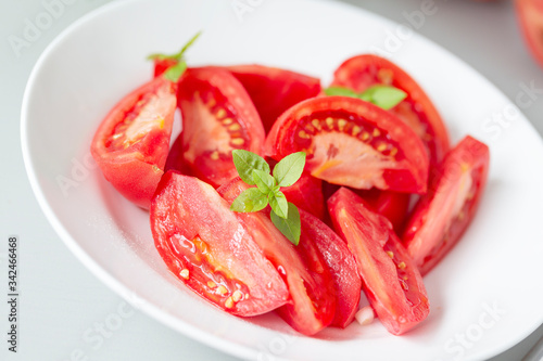 Tomato salad with basil and olive oil in bowl. Selective focus