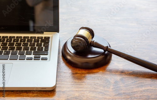 Fotografie Judge gavel and a laptop, wooden background
