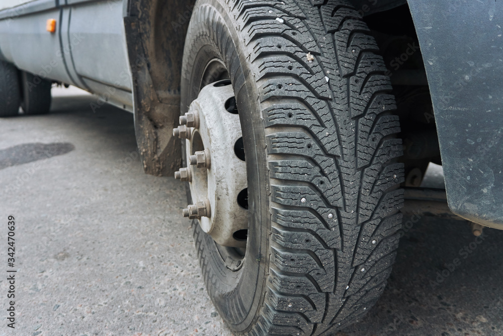 winter wheel, cargo car tire with several missing spikes. winter wheel, cargo car tire with several missing spikes.