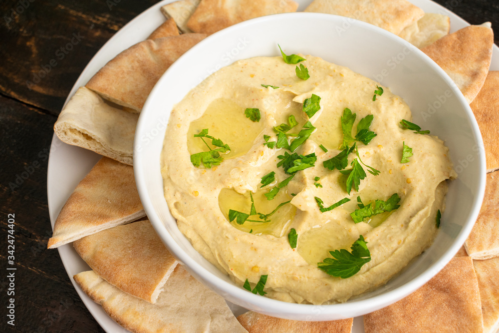 Baba Ganoush with Pita Bread: Eggplant dip made with garlic and tahini drizzled with olive oil and garnished with chopped parsley