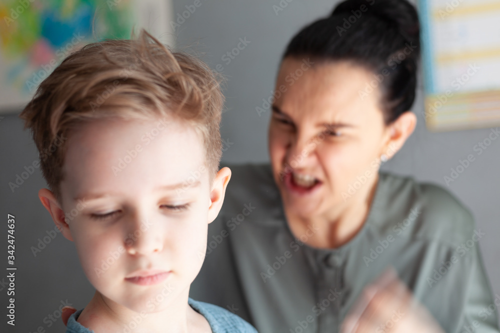 young mother scolds her son, the boy turned away from the angry mother young mother scolds her son, the boy turned away from the angry mother