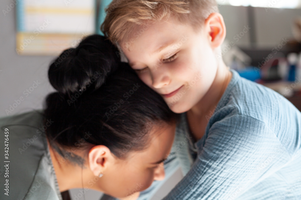 smiling young mom and little preschooler son embrace look at camera posing at home smiling young mom and little preschooler son embrace look at camera posing at home