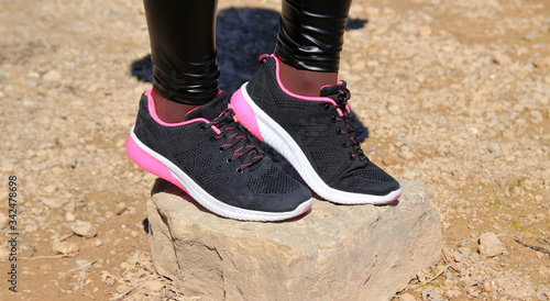 black sneakers on the stone