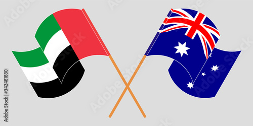 Crossed and waving flags of Australia and the United Arab Emirates
