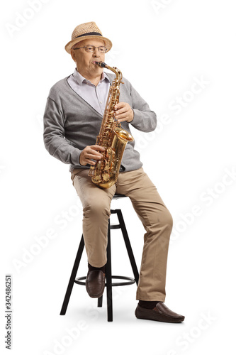 Elderly gentleman sitting on a chair and playing a sax