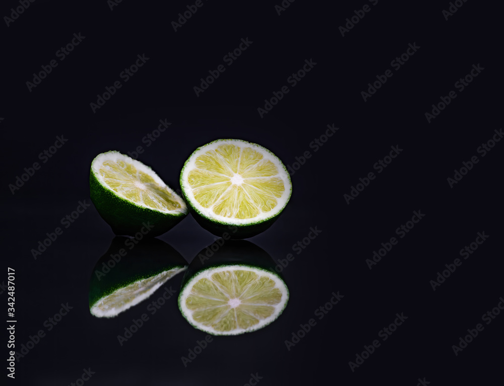 cut lime on black with reflection