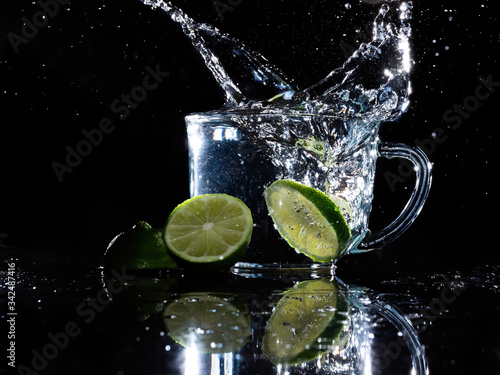 lime splashing in glass mug