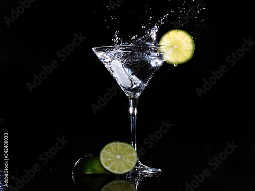 ice splash in martini glass with lime