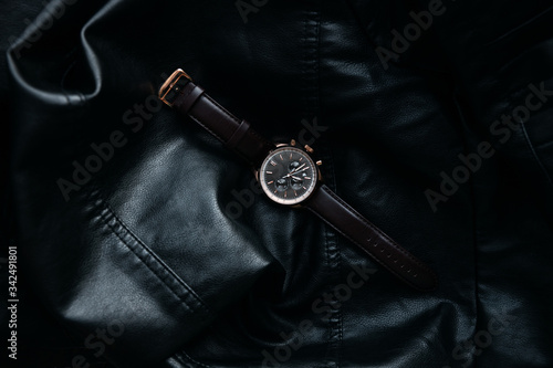 Gold LEATHER WATCH, VINTAGE STYLE WRIST WATCH, MEN'S LEATHER WATCH on leather background blur.