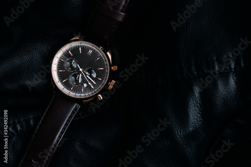 Gold LEATHER WATCH, VINTAGE STYLE WRIST WATCH, MEN'S LEATHER WATCH on leather background blur.