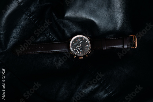 Gold LEATHER WATCH, VINTAGE STYLE WRIST WATCH, MEN'S LEATHER WATCH on leather background blur.