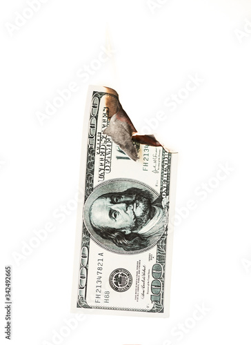 Burning hundred dollars cash on white background