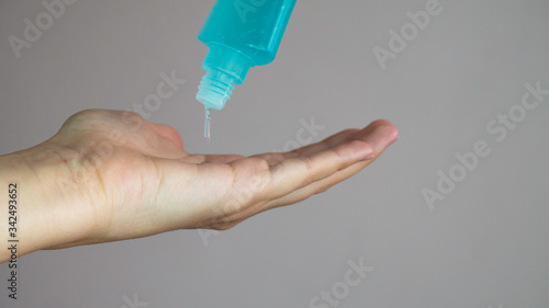 Bottle with antibacterial antiseptic gel in hand.