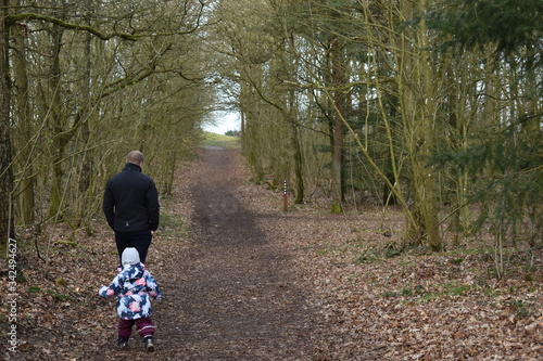 Father and daughter in a beautiful tunnel of trees