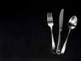 knife fork and spoon on black