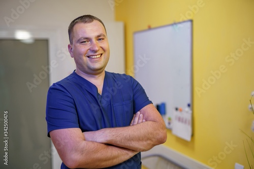 Doctor stands crosshands near board. Seminar for doctors. Methods for treating patients. photo