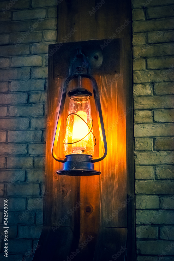 Lamp in the old style on the wall. Restaurant interior in the morning.