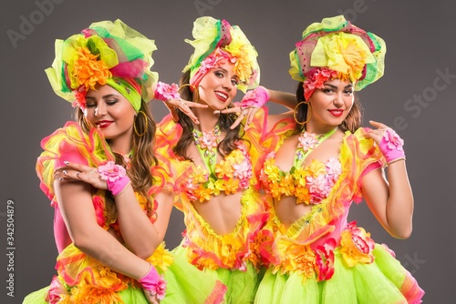 Showgirls in colorful dresses shot