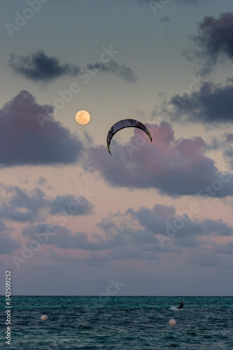 Kitesurfing with full moon and dramatic skies in Cayo Guillermo, Cuba photo