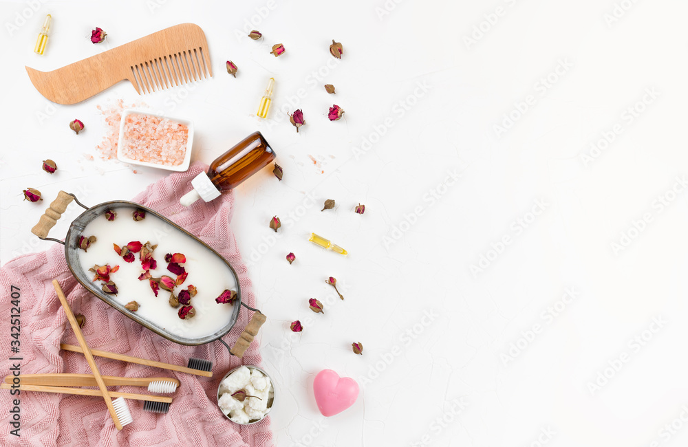 self-care kit for body, hair, face. soap nuts, rose petals, coconut oil, bath , bamboo brushes, salt, pink towel. DIY eco cosmetics. concept zero waste, no plastic, sustainable. copy space. flat lay self-care kit for body, hair, face. soap nuts, rose petals, coconut oil, bath , bamboo brushes, salt, pink towel. DIY eco cosmetics. concept zero waste, no plastic, sustainable. copy space. flat lay