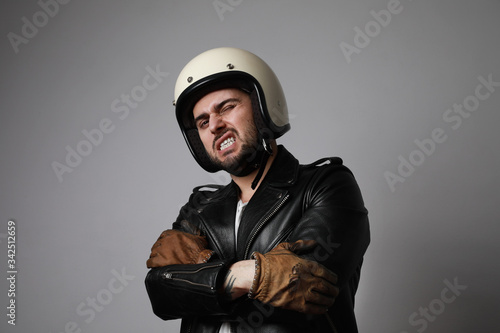 Handsome bearded man over white background with angry face wearing white helmet.