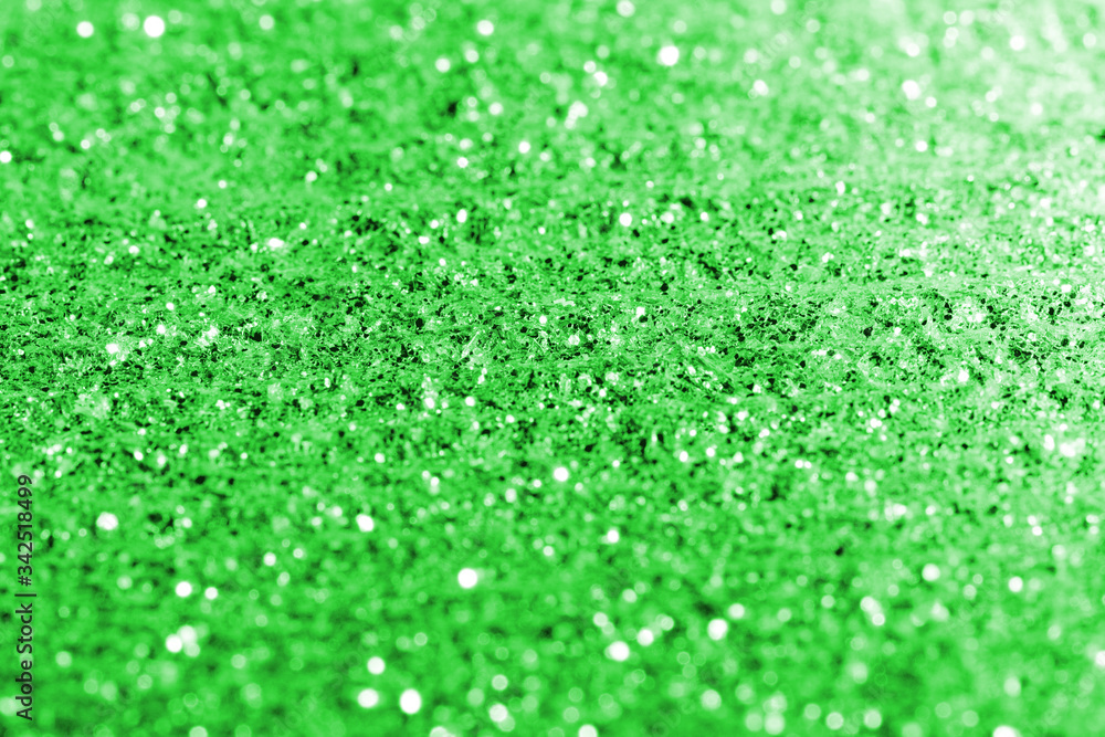 Fototapeta premium blurred green glitter texture festive abstract background, workpiece for design, soft focus
