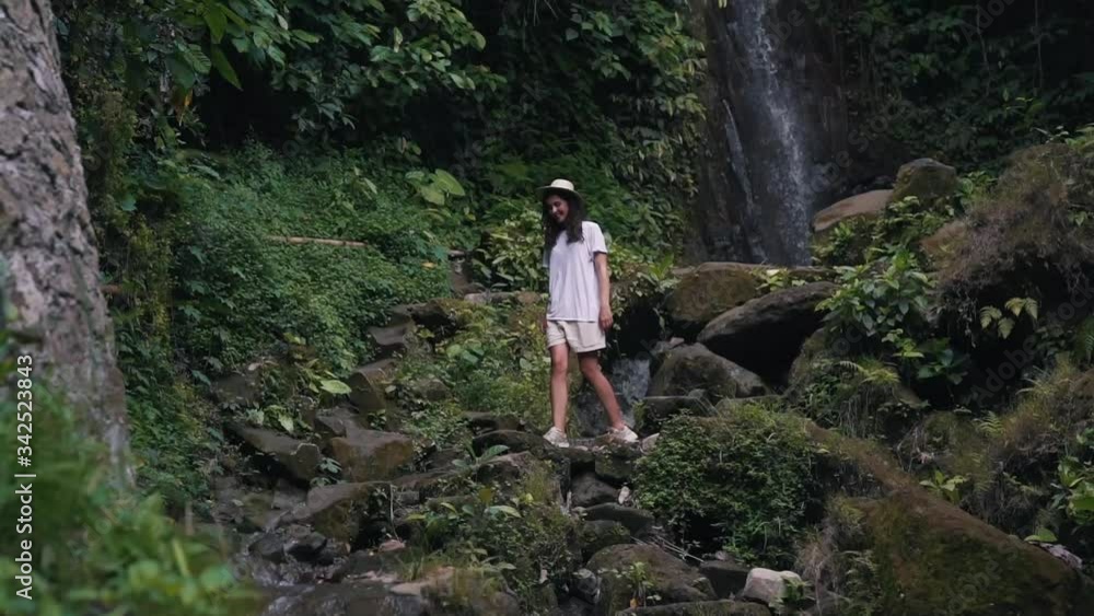 girl walks in jungle at the waterfall girl walks in jungle at the waterfall